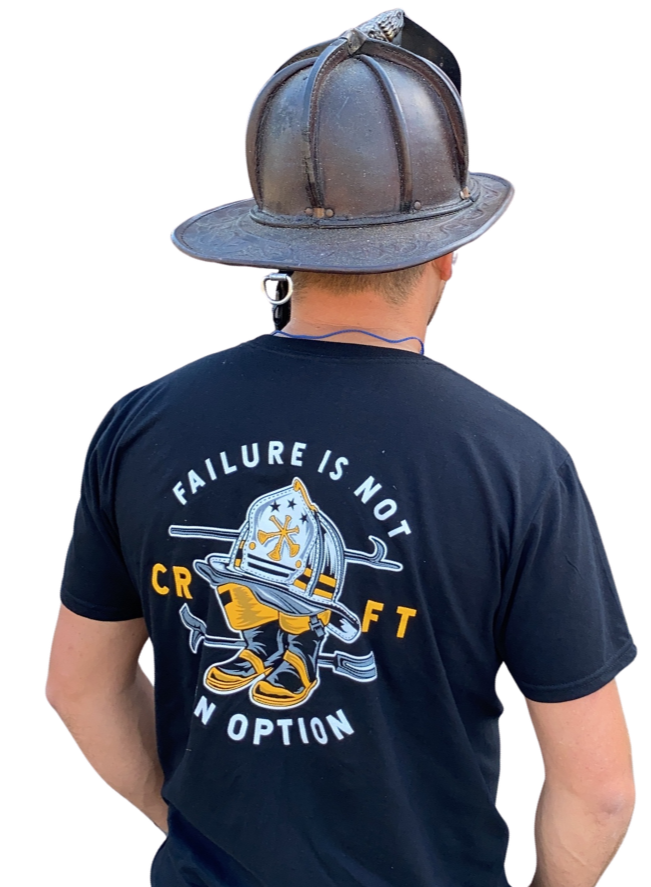 Firefighter shown from behind wearing a helmet and Combat Ready Fire shirt.